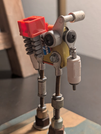 Three-view composite (front, side, back) of the American Sentinel AF-5 robot sculpture, featuring a vintage orange American Parts fuse tin body and upcycled RCA connector arms.